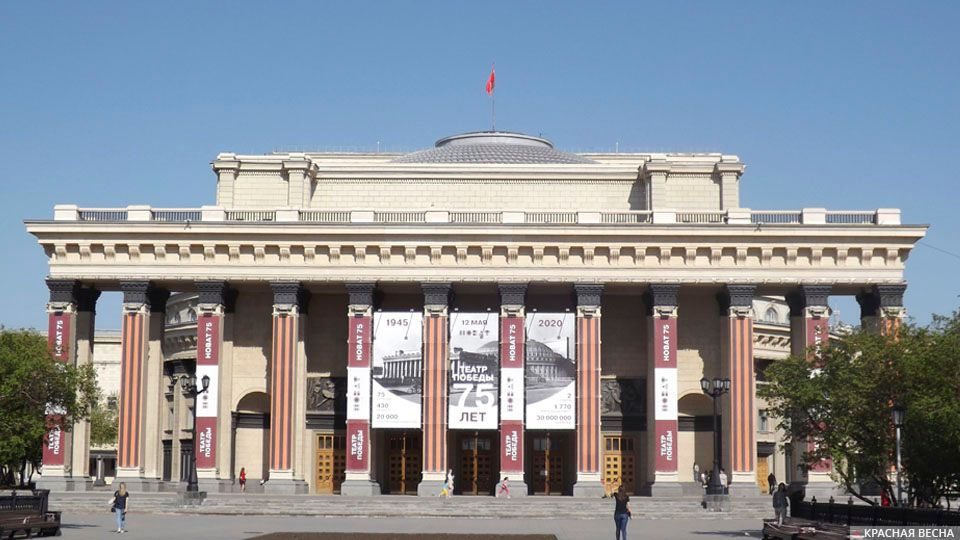 Новосибирский академический театр оперы и балета 9 мая 2020 года с установленным над куполом Знаменем Победы и афишей онлайн-концерта «Театр Победы»