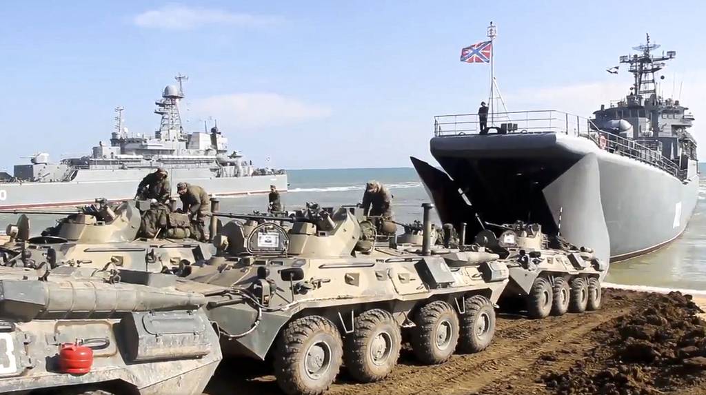 Российская военная бронетехника заезжает на десантные корабли после учений в Крыму 23 апреля 2021 года