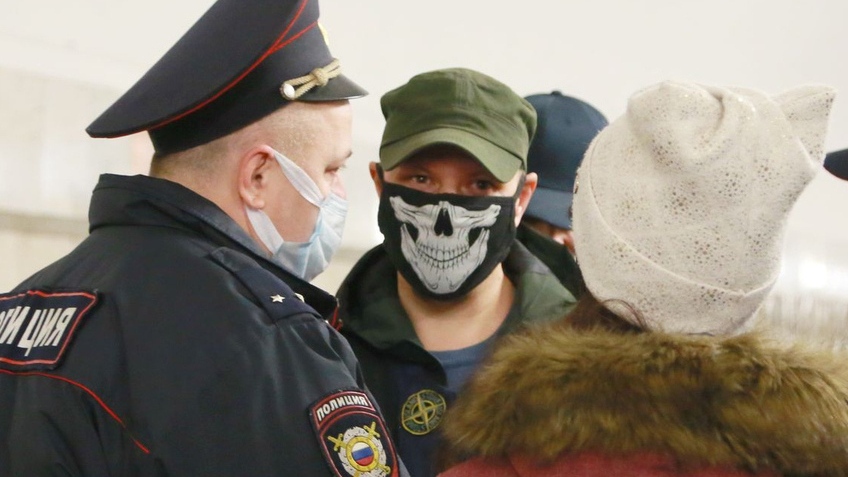 Сотрудник полиции беседует с участником «Русского марша»