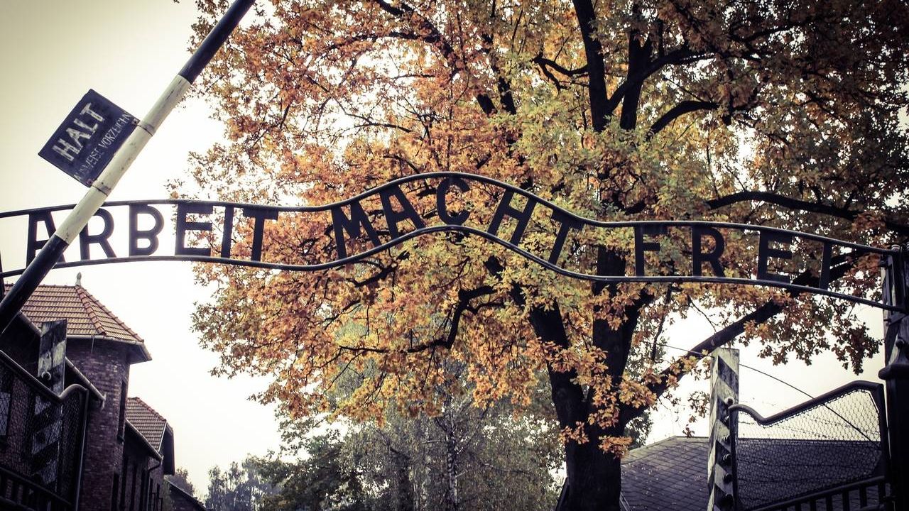 Надпись при входе в лагерь: «Работа делает свободным». Освенцим