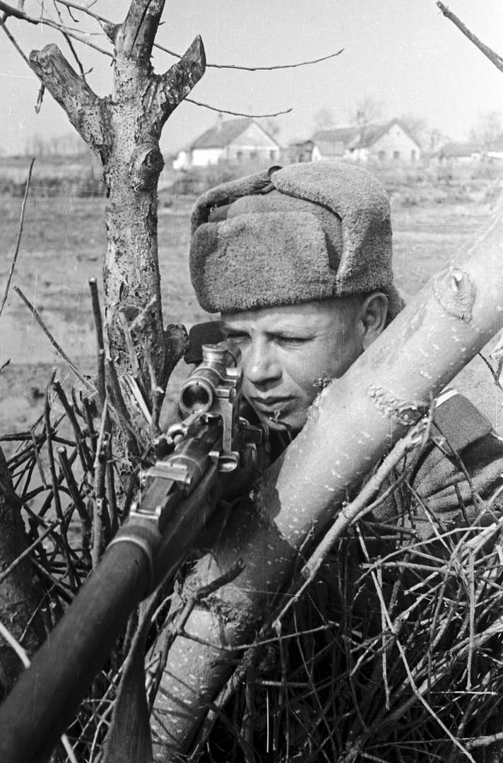 Ольга Ландер. Снайпер 3-го Украинского фронта сержант В. Коршун на позиции в районе озера Балатон. Март 1945 г.